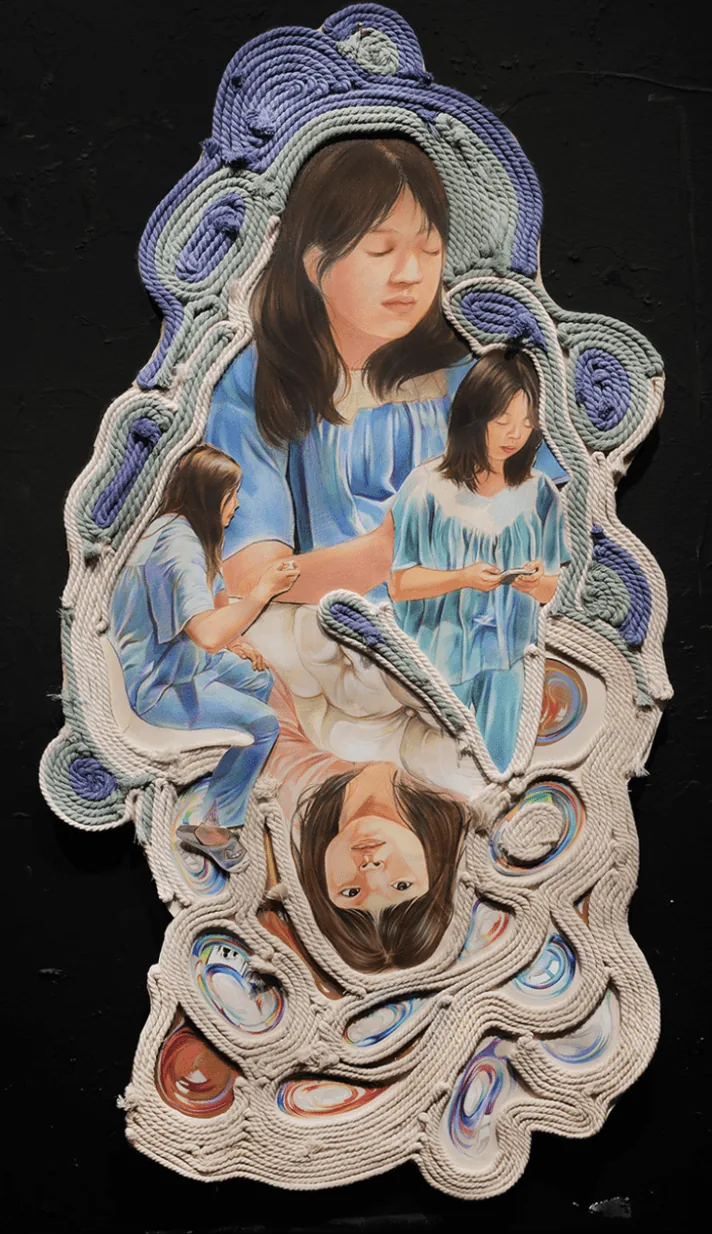 Layered paper collage of girls in blue reading, framed by swirling quilled paper borders