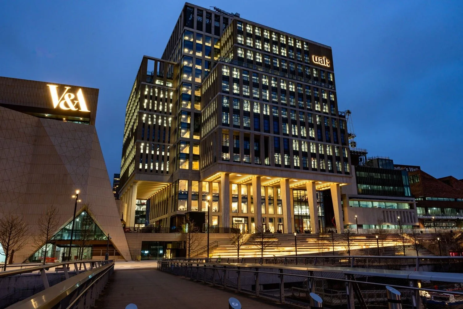 University of the Arts London campus and V&A East buildings lit up at dusk in London's East Bank